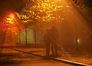 People walk in fog and light