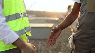Roof inspectors doing hand shaking while standing outdoors