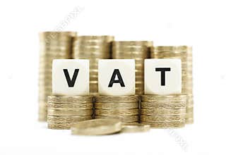 VAT (Value Added Tax) on gold coins on white backg