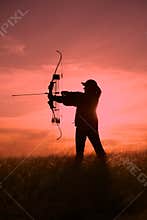 Female Bowhunter in Sunset