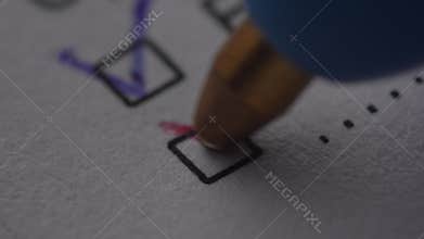 Pen Marking a Checkbox with Red Ink.