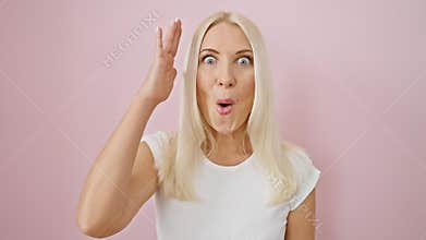 Shocked and scared! young blonde beauty\'s face reflects fear and amazement. her astonished expression speaks volumes, standing