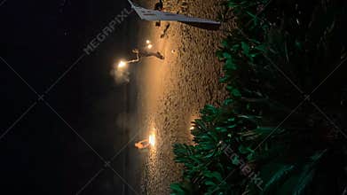 Thailand, Phuket, 14 November 2023 - Time lapse of the performance of the master of fire with burning torches on the