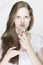 Portrait of young female model holding a glass of drink