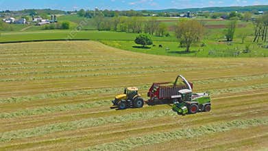 Harvest Dance: Tractors Bale Hay in Golden Fields with azure skies