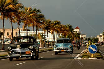 Old cars on malecon in Cienfuegos, Cuba