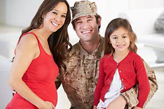 Family Greeting Military Father Home On Leave