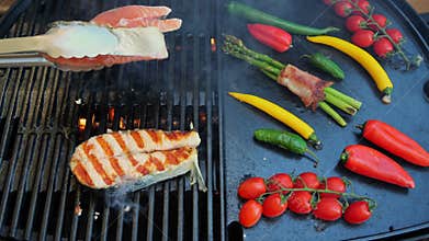 Salmon steak turn over with on the cast iron grill barbecue. Seafood. Salmon grilled.