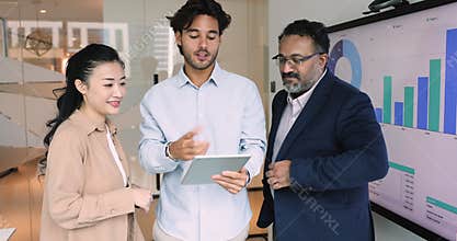 Businesspeople collaborate using sales tracker app on digital tablet
