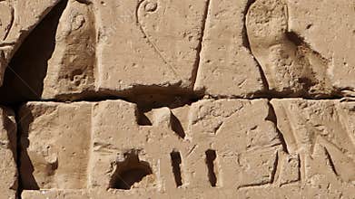 Ancient Egyptian hieroglyphs and bas-reliefs close-up in Temple of Medinet Habu. Egypt, Luxor. The Mortuary Temple of