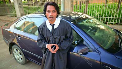 Lawyer standing in front of a car and talking
