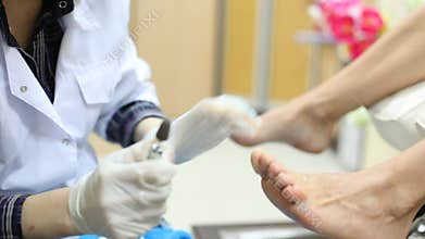 Beautician grinds woman foot on doing pedicure in