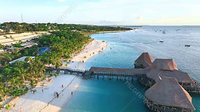 Aerial view of beautiful bungalow and sea at sunset in summer