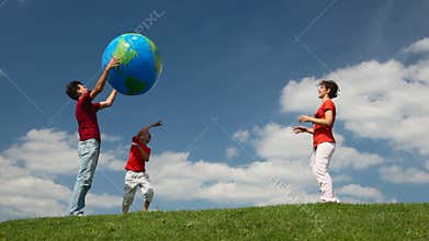 parents and son playing big inflatable ball on
