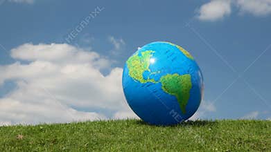 globe looking inflatable ball waving by wind on
