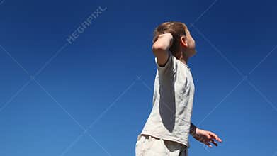 boy turns, says and looks showing his hand up