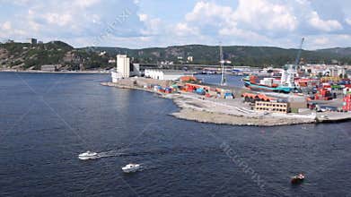 Powerboats draw away from of terminal of cargo