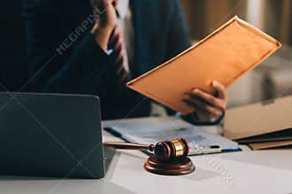 Male lawyer working with contract papers and wooden gavel on tabel in courtroom. justice and law ,attorney, court judge, concept