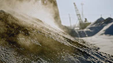 Ore mining in winter. Stock footage. Close-up of hot fossil releases steam on surface of earth. Extracted pile of
