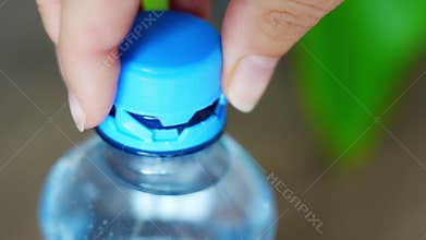 Stationary plastic cap on a PET bottle. The new design means the cap remains attached to the bottle after opening