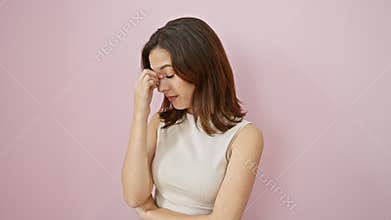 Exhausted young hispanic woman tiredly rubbing eyes, head aching in frustration. beautiful female in sleeveless t-shirt over