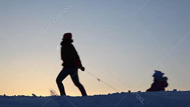 Silhouette mother carries child on