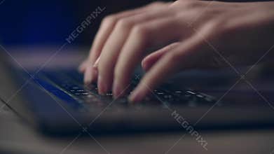 Closeup of hands typing on laptop keyboard, emphasizing technology and productivity in office