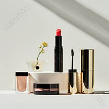 Clean copy space featuring a selection of luxury makeup products.