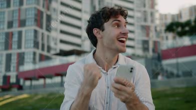 Amazed Caucasian business man winner male winning with mobile phone wonder surprised cheerful businessman guy win with