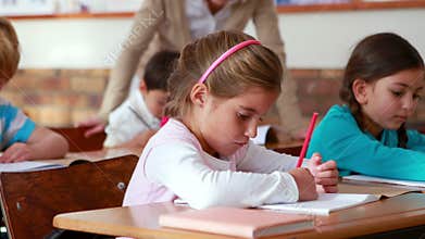 Schoolchildren colouring in books in classroom