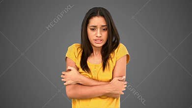 Woman shivering with cold on grey background