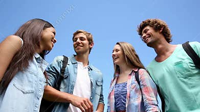 Happy students standing outside chatting