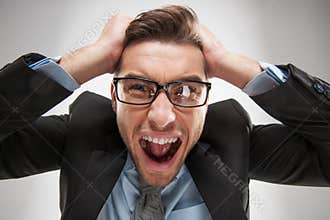 Closeup portrait of angry, frustrated man, pulling his hair out.