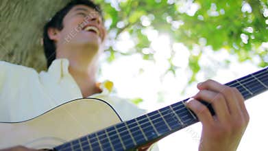 Cheerful man playing the guitar