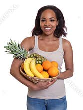 African woman holding a basket of fruits