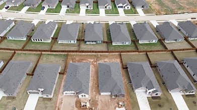 Completed homes and active builds line Arabian Ln at Highpointe Ranch by FM 1385, Spring Hill Rd in Aubrey. Gray roofs, fenced