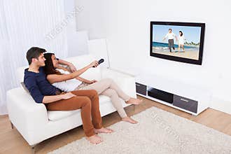 Couple watching tv in living room