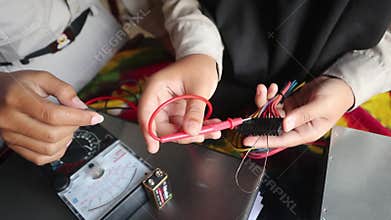 School students in Java, Indonesia, practice measuring DC electrical power