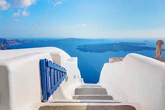 Santorini, Greece. Open blue door with Aegean sea view and Caldera.
