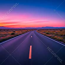 Open desert highway curves towards a stunning sunset with vibrant pink and purple twilight skies