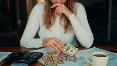 Worried face upset female views expenses planning budget. sad tired young woman sitting at desk checking utility bills