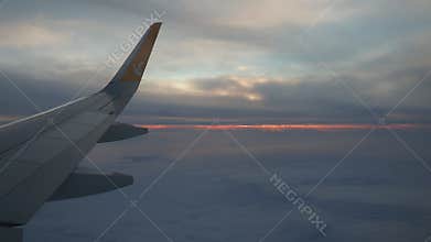 Istanbul, Turkiye - January 24, 2026: Pegasus Airlines Plane Wing Over Evening Clouds. Sunset Peeking Through Haze. Aircraft