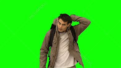 Handsome man walking towards the camera on green screen