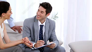 Couple discussing with a salesman