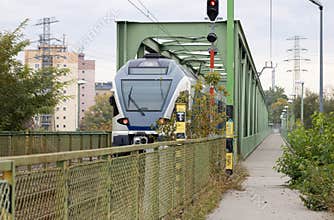 Train on green metal bridge