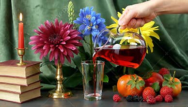 Still life with flowers candle books and fruit creating a cozy and inviting atmosphere