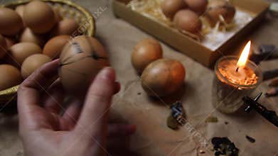 Female hand holding egg and paint pysanka. Preparing for painting Ukrainian Easter eggs decorated with folk designs using a wax