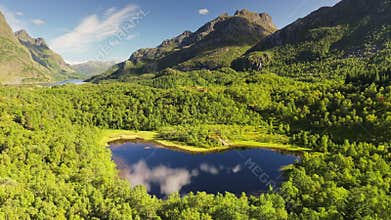 Aerial view of breathtaking natural beauty of Lofoten Islands with stunning mountains, lush forests and lakes. Northen