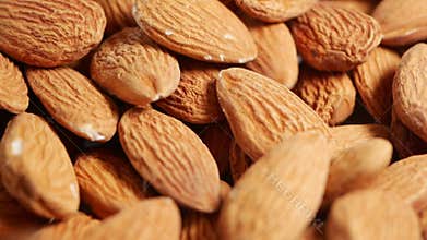 slow motion of fresh almonds dropping on a bowl