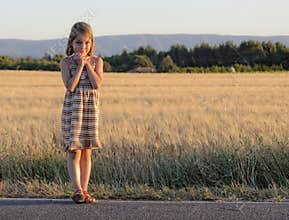 Girl standing at roadside